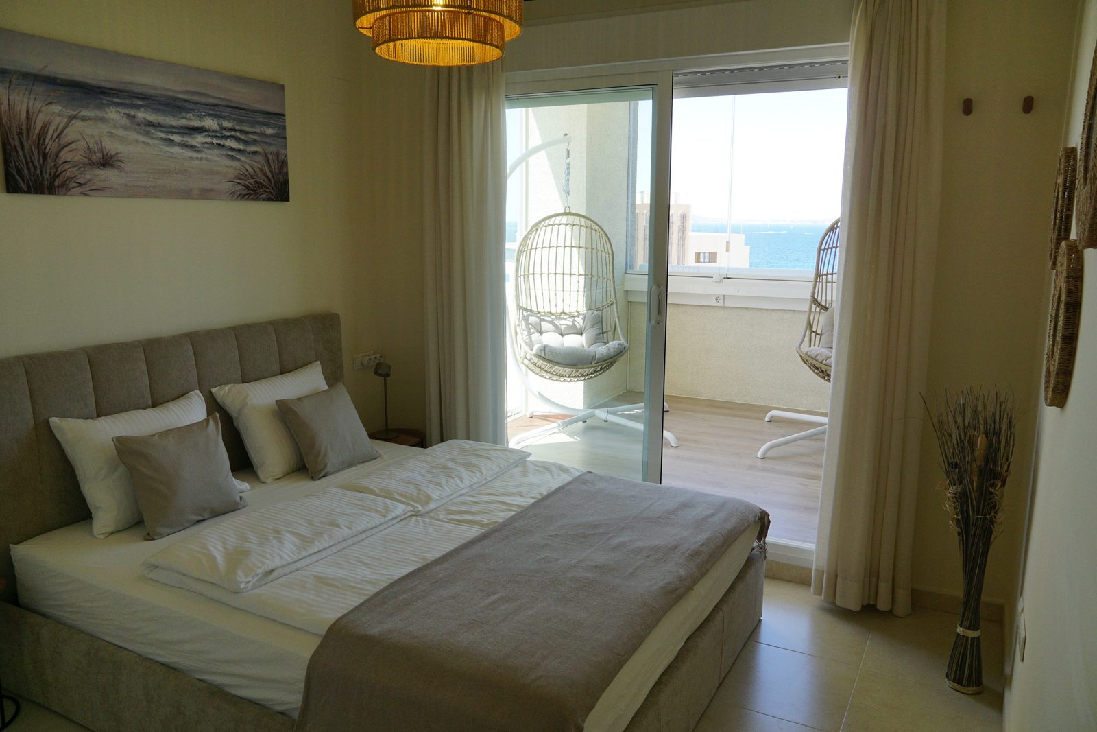 Master bedroom with private balcony, hanging chair and sea view