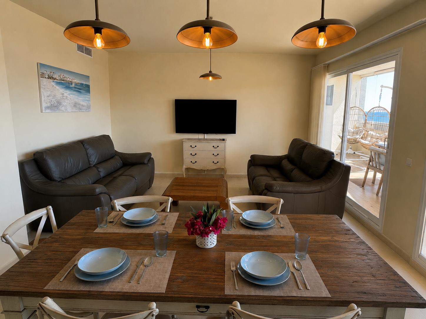 Living and dining room with sofas and dining table