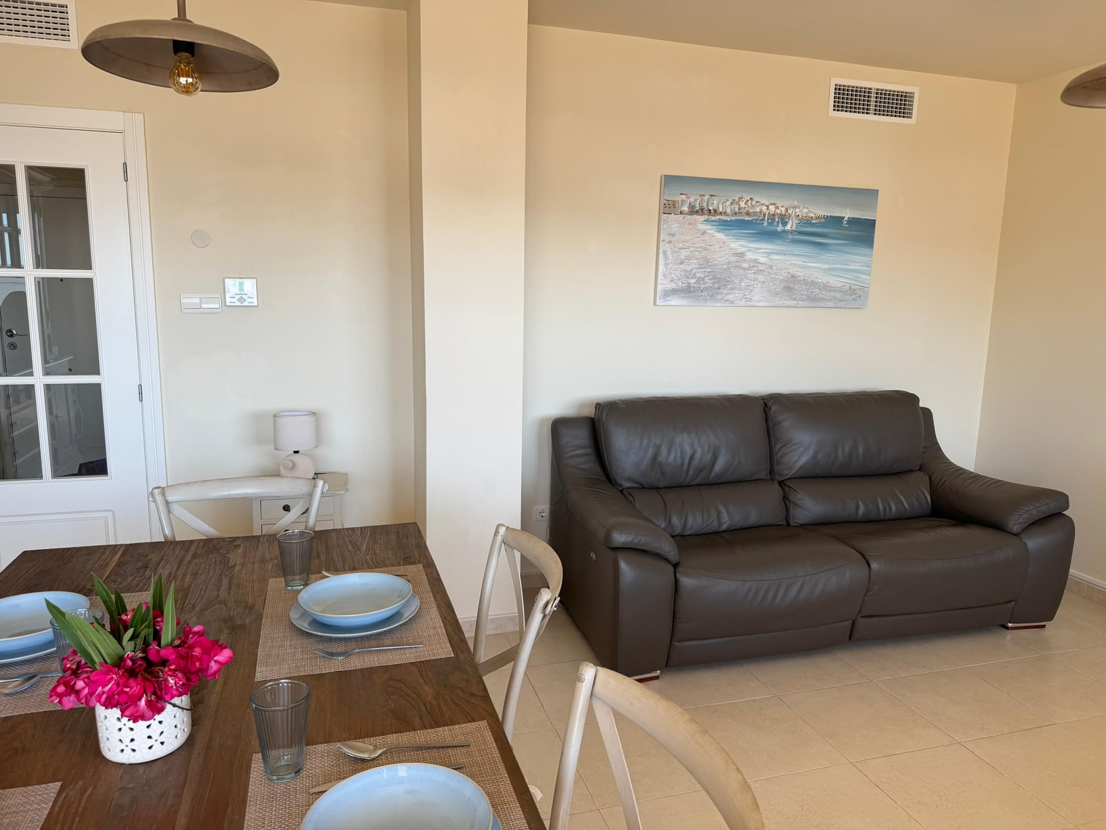 Leather sofa with coastal painting