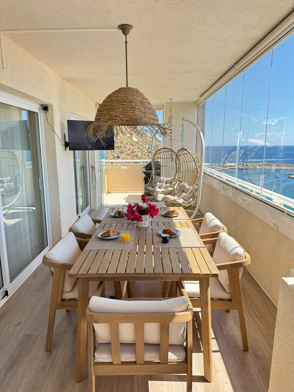 Loggia dining table with sea and marina view