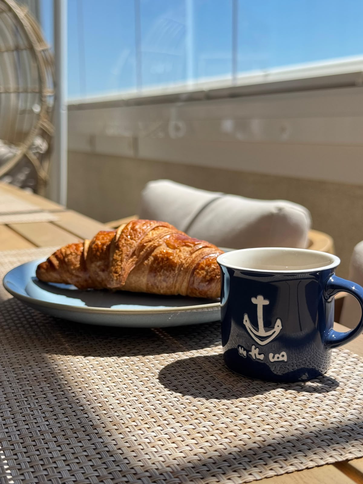 Breakfast croissant and coffee on the loggia