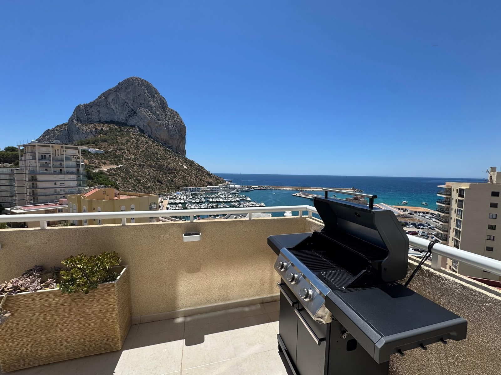 Terrace barbecue with the Ifach rock and marina behind