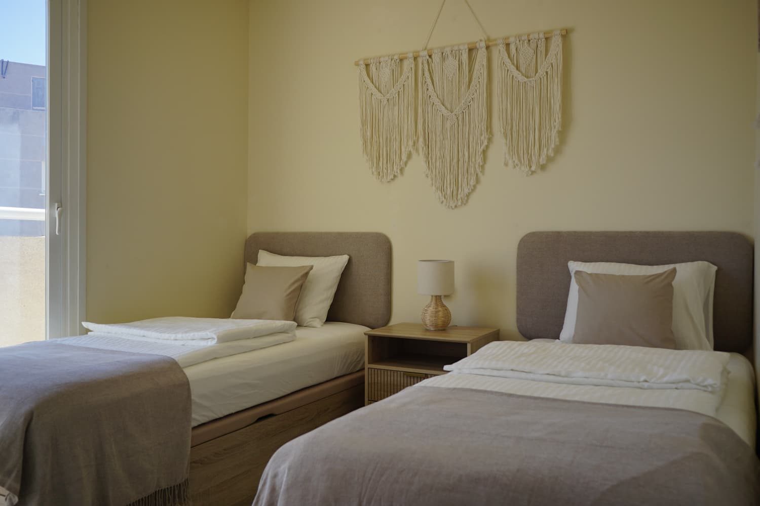 Twin bedroom with two single beds and balcony door